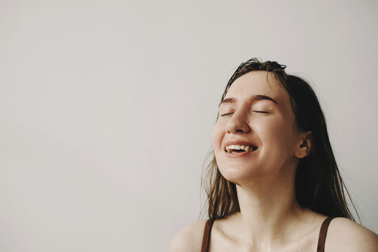 Cheerful woman with wet face