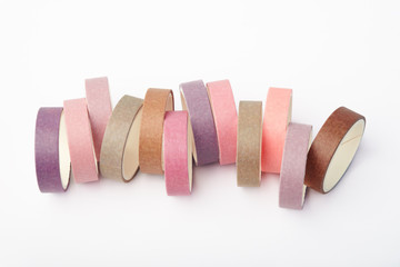 A lot of multi-colored rolls of washi tape on a white background