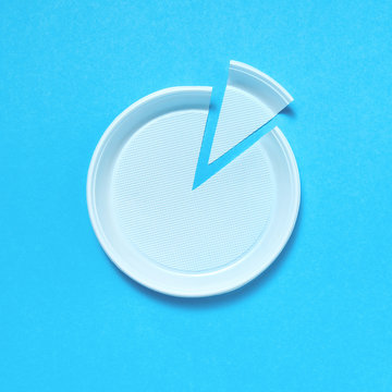 Cut plastic plate on blue background