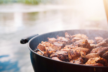 grilled meat in an open-air barbecue. Pork, sausages, beef on the coals.