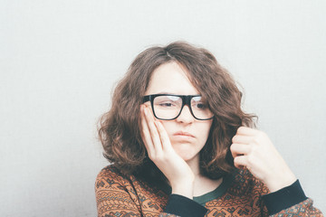 Girl has a toothache wearing glasses