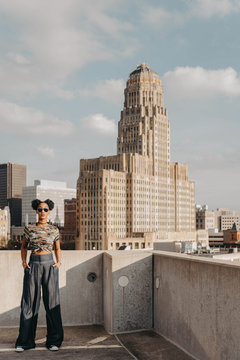 A beautiful African American girl in her twenties having fun against a city skyline