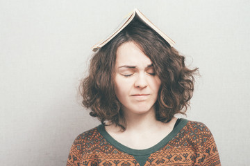 girl with a book on his head