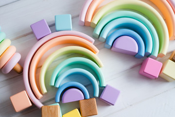 Wooden colorful toys. A wooden pyramid, rainbows and cubes.