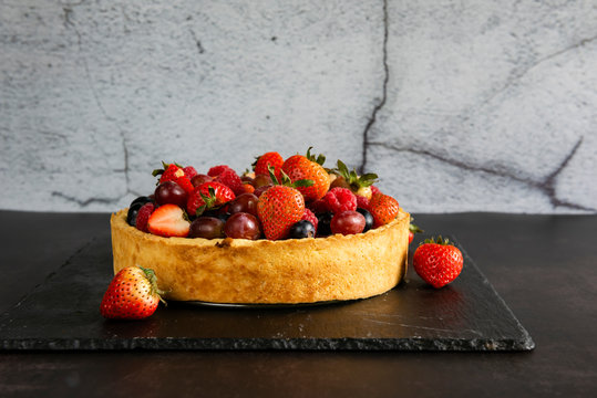 Fruit tart with fresh raspberry, blueberry, strawberry and grape