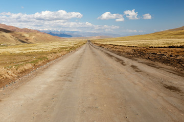 Fototapeta na wymiar A367 highway, passing in the Naryn region of Kyrgyzstan, near the village of Uzunbulak in Kochkor District