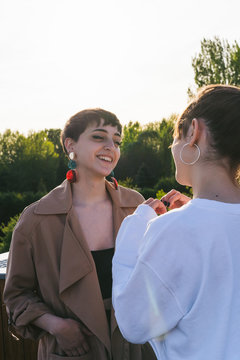 Two Girls Talking Outdoors.