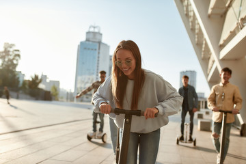 Get better rides. A group of friends using kick scooters and segways on a sunny day