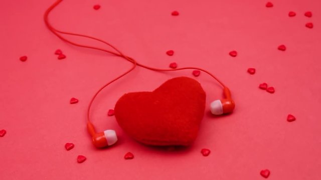 Red heart and red headphones. hearts on a red background. Heart and headphones. listen to the heart