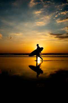 Silhouette of a surfer on the beach at sunset. Costa Rica Pura Vida.