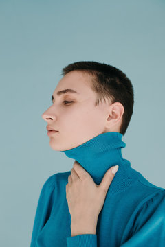Model in sweater on light blue background