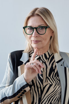 Aged Woman Touching Chin With Forefinger Portrait