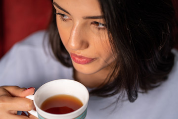 close up woman drinking tea