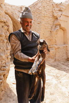 Man holding a little goat