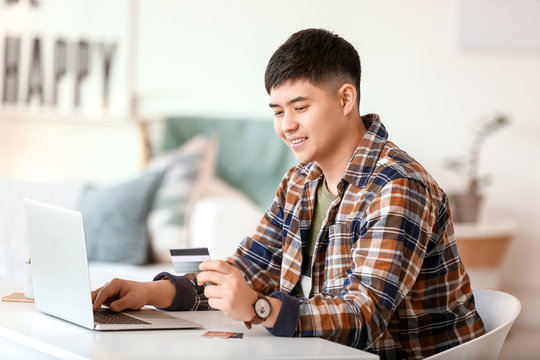 Asian Man Shopping Online At Home