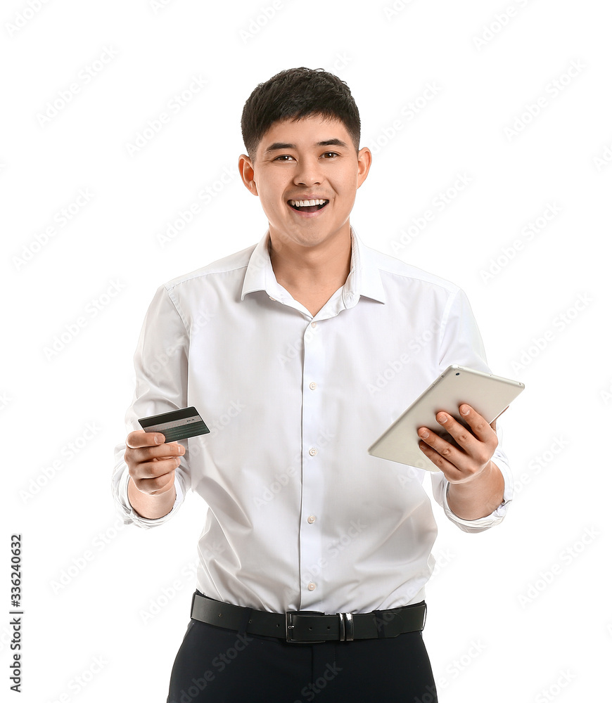 Wall mural Asian businessman with credit card and tablet computer on white background