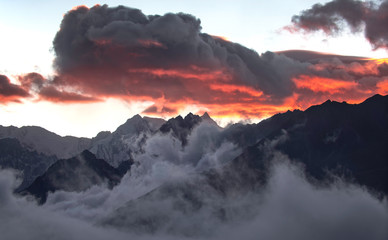 Sunset and Fiery Sky over Foggy Himalayan Mountain Peaks