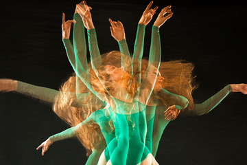 Multiple exposure of ballerina in green, dancing in the studio.