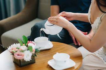 Fototapeta na wymiar Tea drinking black tea with porcelain cups and a teapot