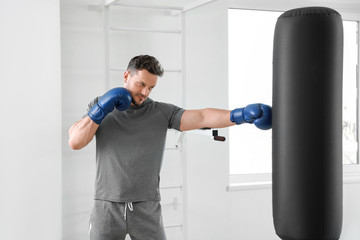 Male boxer training in gym