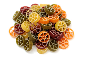 a group of colorful wheel pasta on white background
