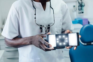 Close-up of dentist holding special photographic apparatus