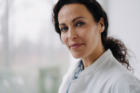 Portrait of confident female doctor, looking at camera