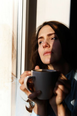 Portrait of pretty girl with cup of coffee