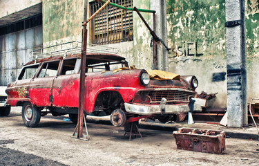 Old american car in a workshop in havana - 336247645