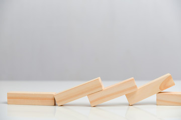 Business ruin concept. Wooden blocks on a white background background.