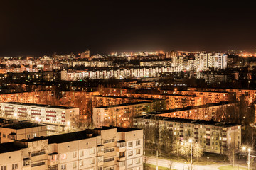 night view of nine-story houses and streets with lanterns, Belarus Vitebsk, architecture abstract background