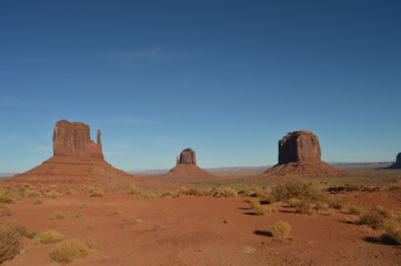 Fototapeta na wymiar Iconic West and East Mitten Buttes at Monument Valley in Utah in early afternoon.