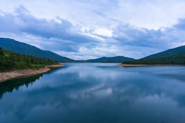 Fototapeta na wymiar Mountain lake landscape. Nozori lake, dam surrounded by mountains