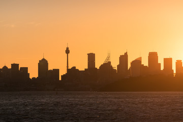 Fototapeta na wymiar Sydney cityscape with bright orange sky and Sydney CBD skyscrapers