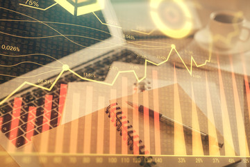 Fototapeta premium Double exposure of financial chart drawing and desktop with coffee and items on table background. Concept of forex market trading