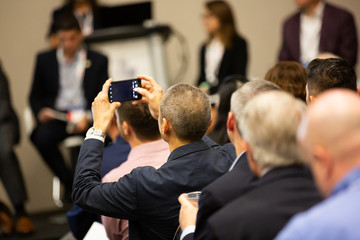 Business man taking photo in conference room
