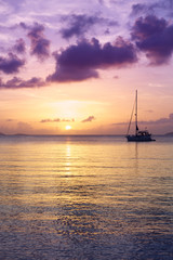 Fototapeta na wymiar Scenic sunset with tropical purple clouds reflecting on calm Caribbean sea