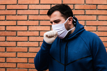 Man is coughing with a medical mask