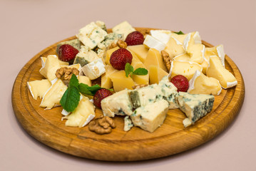 Dairy products, assorted different types of cheeses on a dish. Horizontal frame