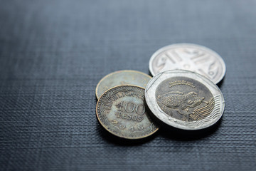 Closeup to a Colombian coins over black background. Ideal for economy, money, banks, save money and finance. 