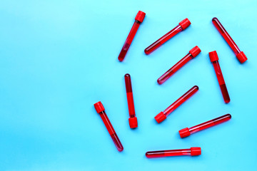 Blood in test tubes on blue background.