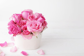 flowers in a vase. pink roses on white background