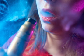The vaper girl. Vaper girl lips close up. Woman with an electronic cigarette. A student with a vape...