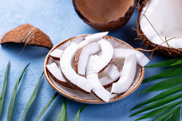 Sliced coconut and palm leaves