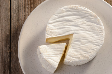 Top view on French Camembert cheese on plate