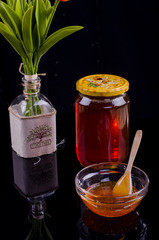 Honey in a jar and tea on a wooden table