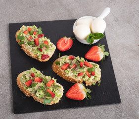 toast with guacamole, avocado, strawberries. mozzarella cheese  healthy eating