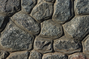 Stone wall as a background.Decorative natural stone. Natural decoration of the facade of the house, building