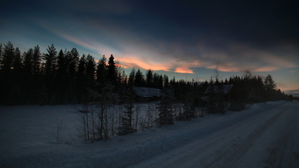 HDR image of nacreous clouds over Swedish farm buildings in winter