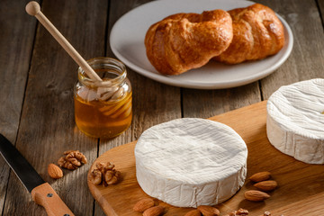Wheel of Brie cheese, almonds, walnuts and honey